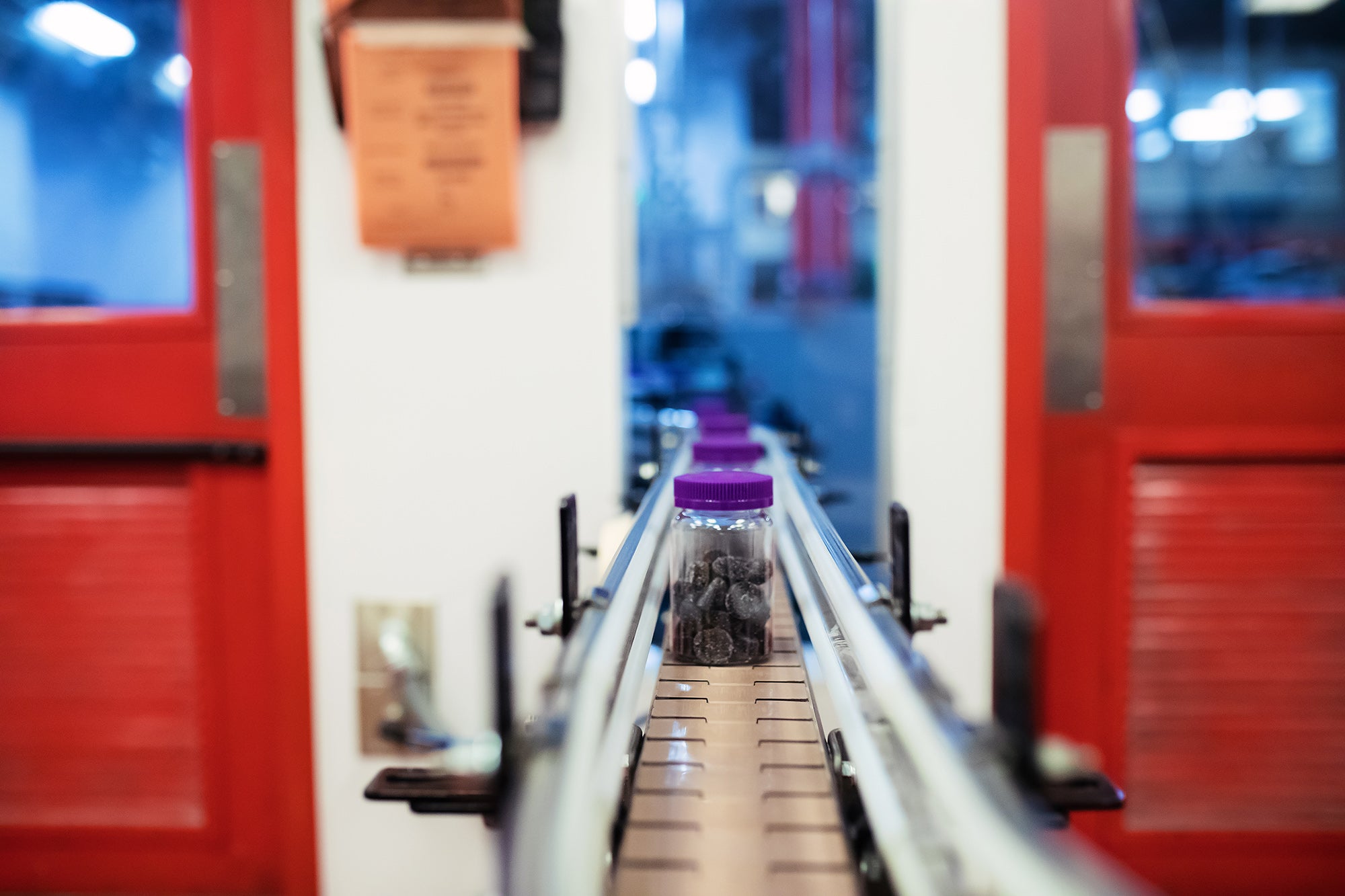 pill bottles coming down a factory conveyor belt